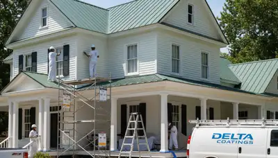 Professional painters painting a home exterior in Memphis, TN